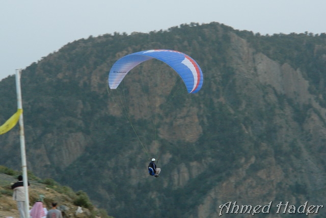adventure parachuting over mountain near clouds